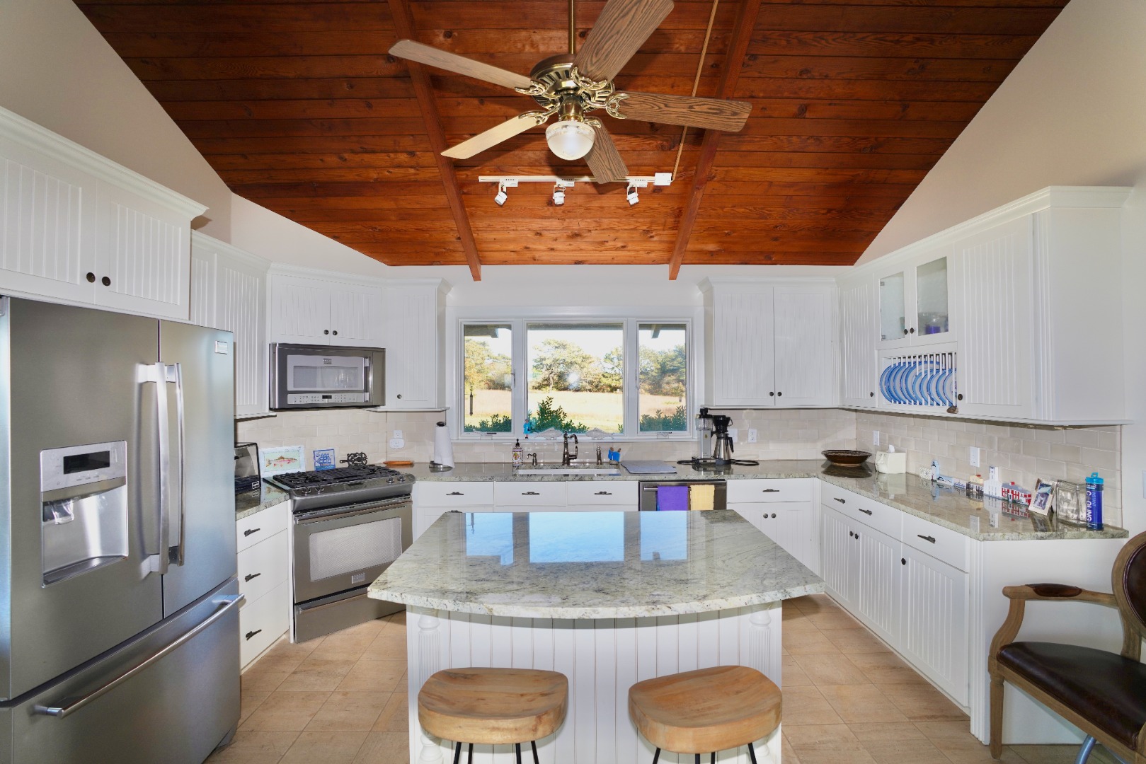 30 Calebs Pond Road Edgartown, MA 02539 - Photo 3 of 35 a kitchen with granite countertop a sink stainless steel appliances and cabinets