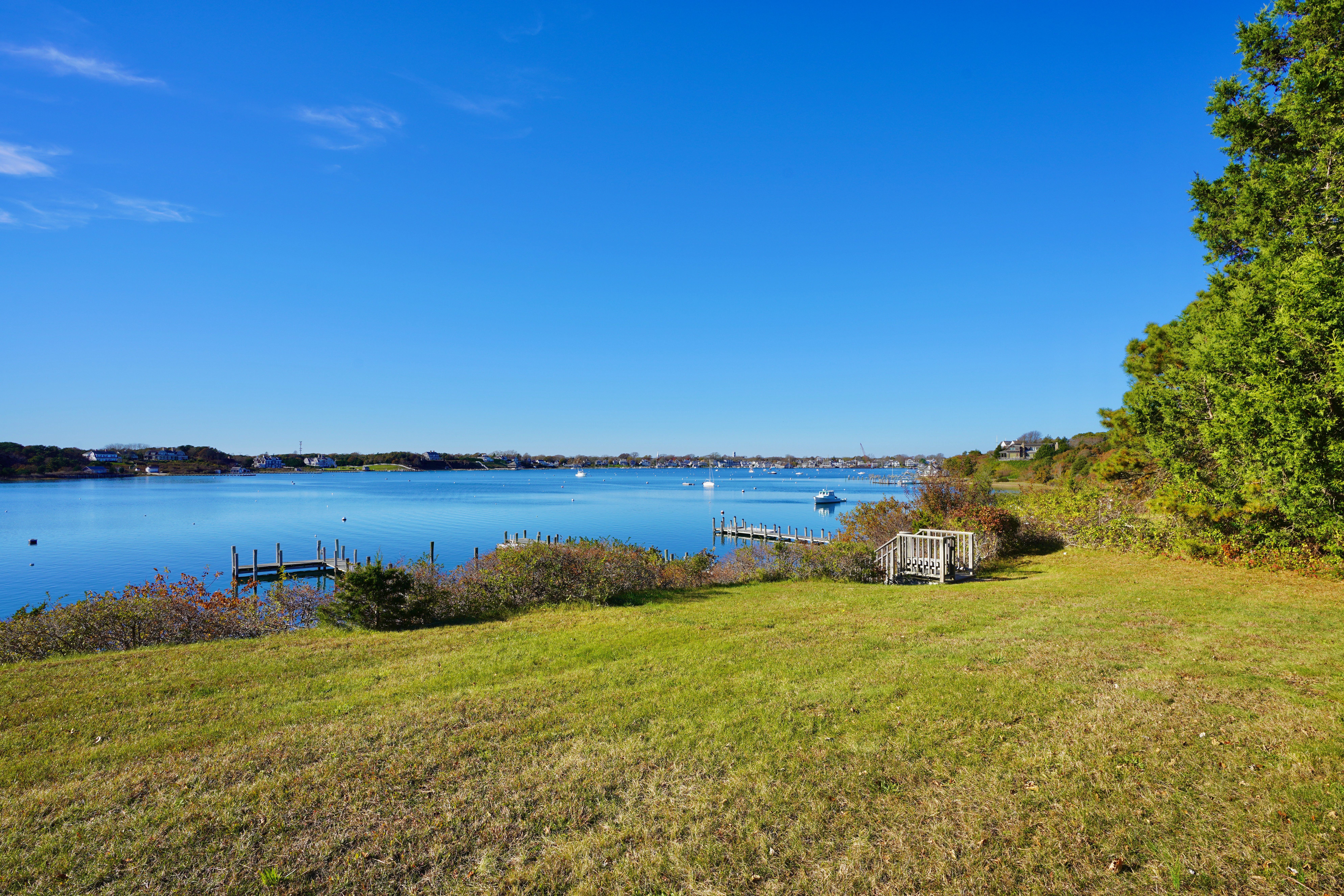 30 Calebs Pond Road Edgartown, MA 02539 - Photo 32 of 35 a view of a lake with houses in the back