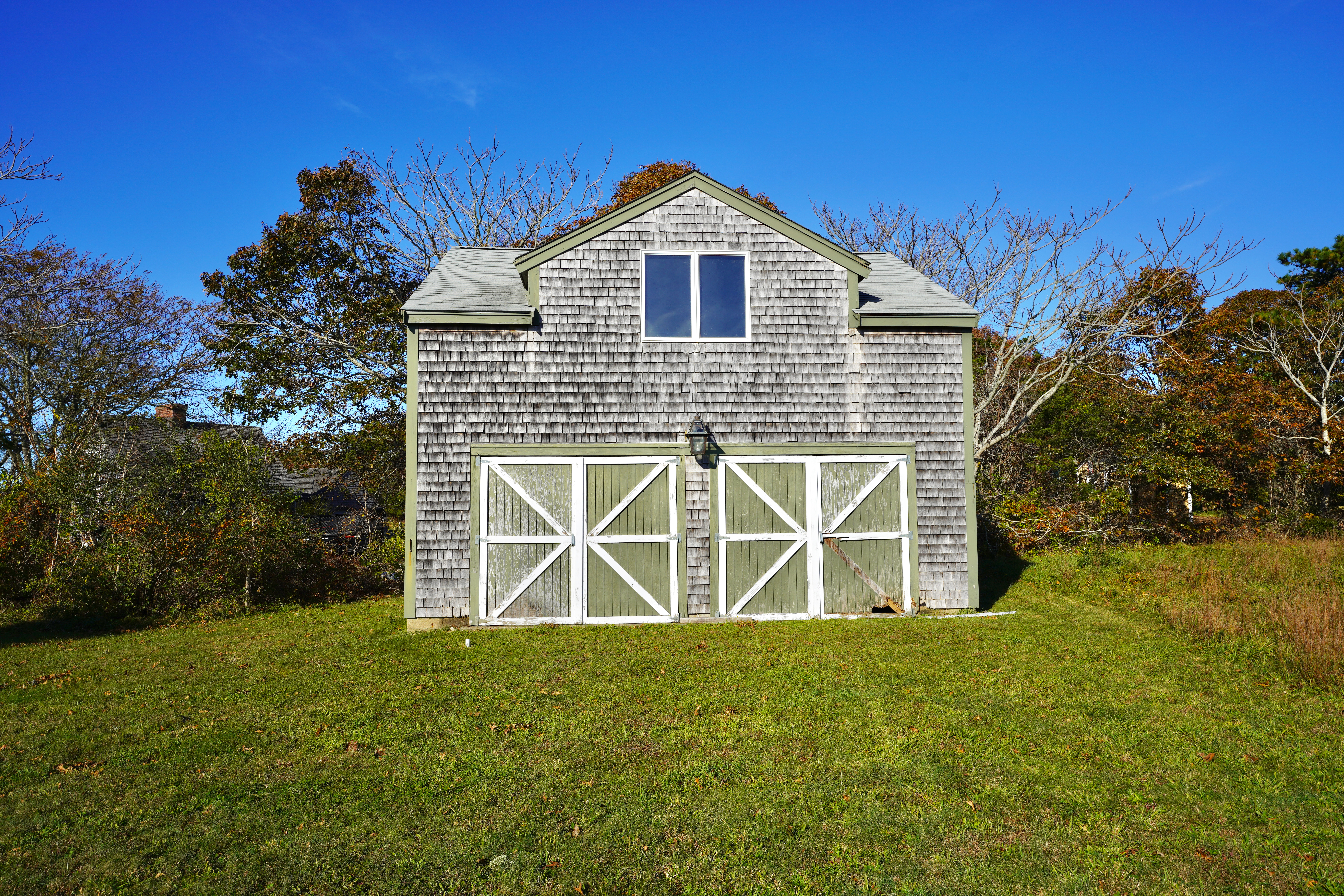 30 Calebs Pond Road Edgartown, MA 02539 - Photo 33 of 35 a front view of a house with garden