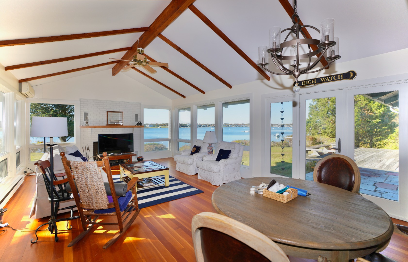 30 Calebs Pond Road Edgartown, MA 02539 - Photo 7 of 35 a living room with furniture a fireplace and a chandelier