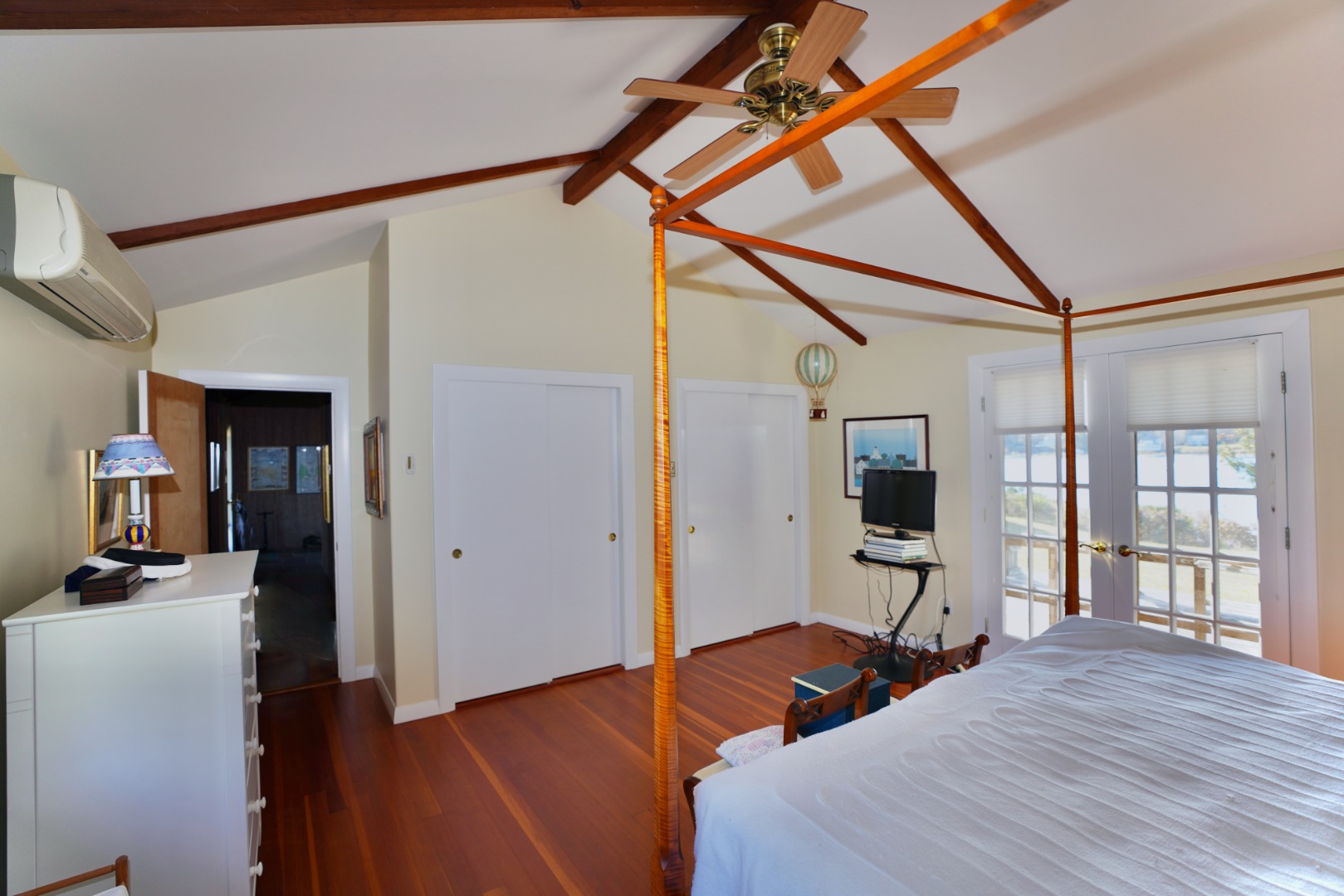 30 Calebs Pond Road Edgartown, MA 02539 - Photo 9 of 35 a bedroom with a bed and wooden floor