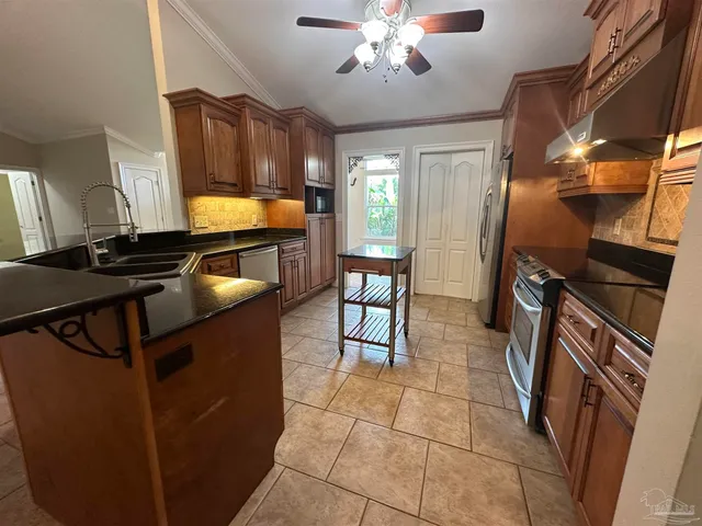 a kitchen with stainless steel appliances granite countertop a sink and cabinets