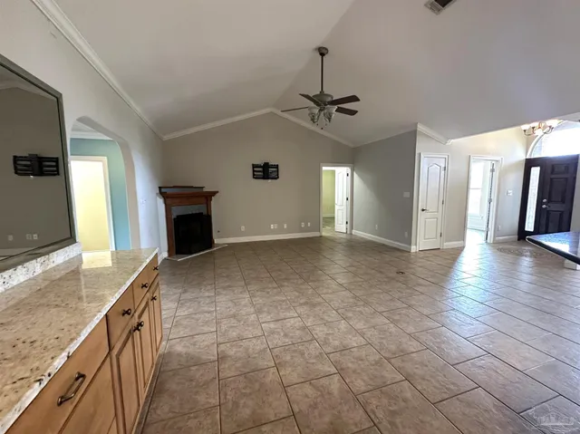 a view of an empty room with a fireplace and a window