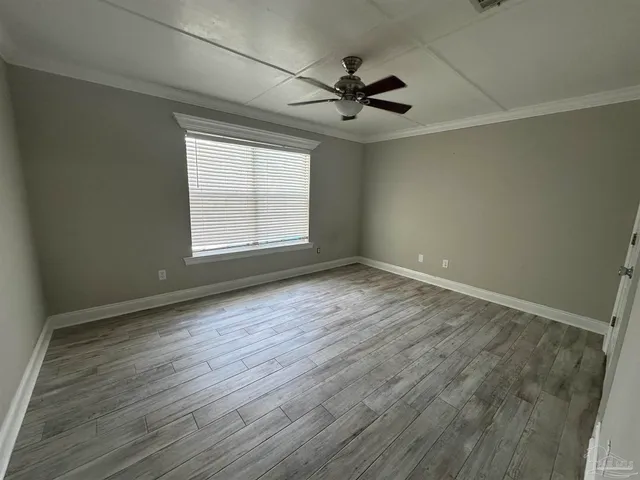 wooden floor in an empty room with a window