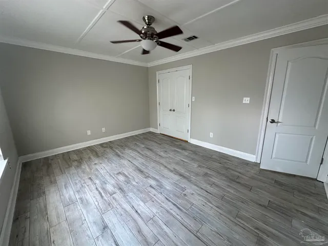 a view of walk in closet with empty racks
