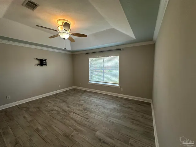 a view of walk in closet with wooden floor