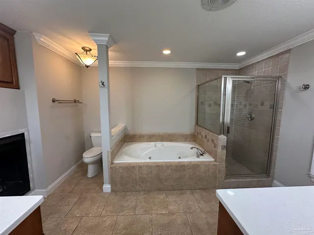 a room with a fireplace a sink and a mirror in it