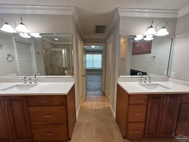 a bathroom with a sink vanity and mirror