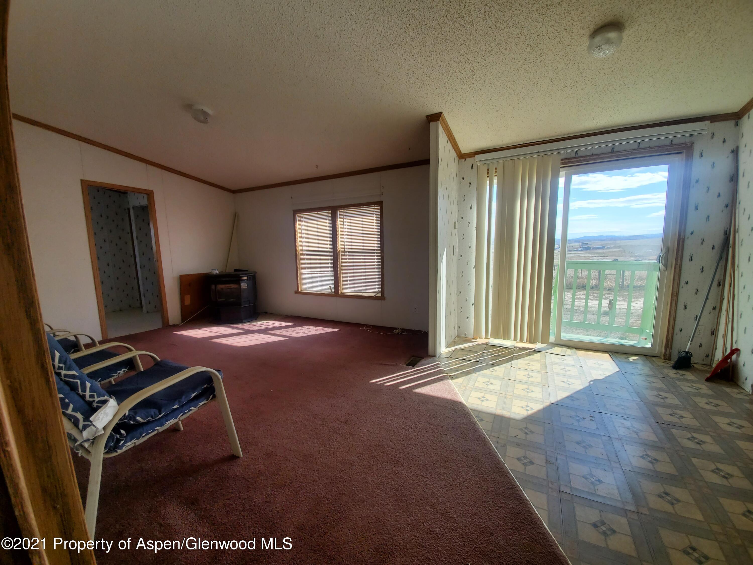 275 Roberts Road Craig, CO 81625 - Photo 11 of 16 a bedroom with a bed and a flat tv screen next to a window