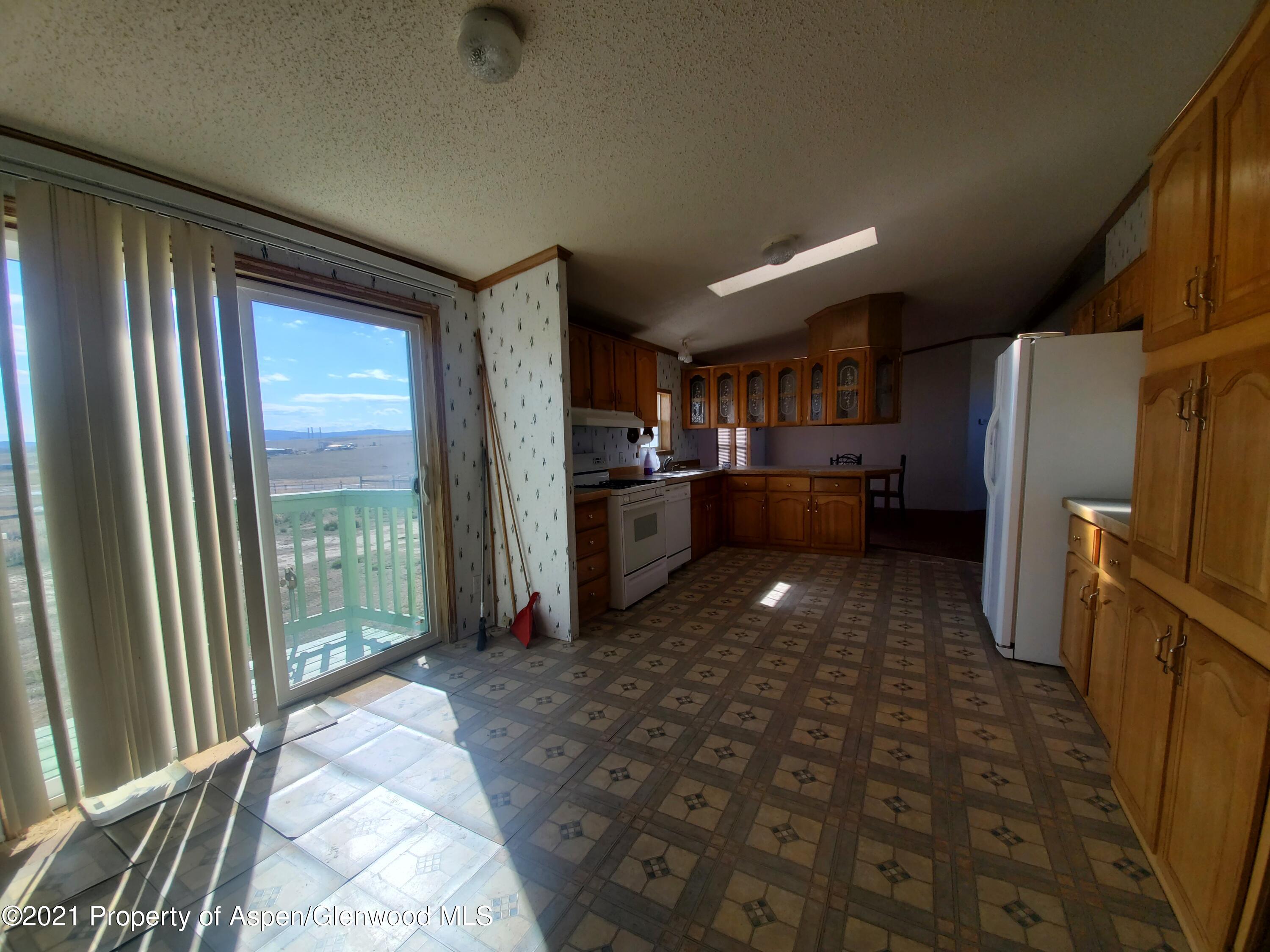 275 Roberts Road Craig, CO 81625 - Photo 12 of 16 a kitchen with stainless steel appliances granite countertop a refrigerator and a sink