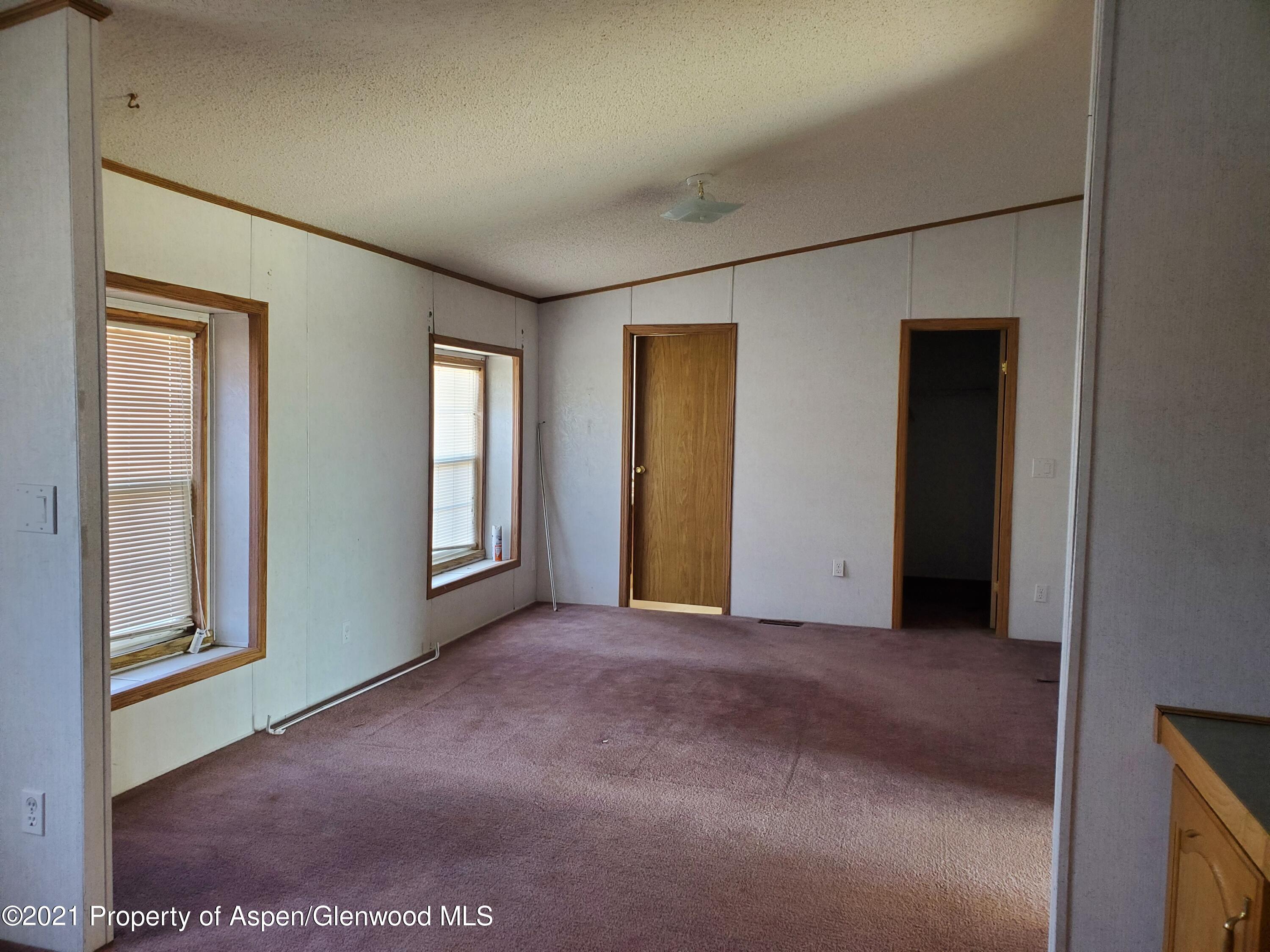 275 Roberts Road Craig, CO 81625 - Photo 13 of 16 an empty room with windows and closet