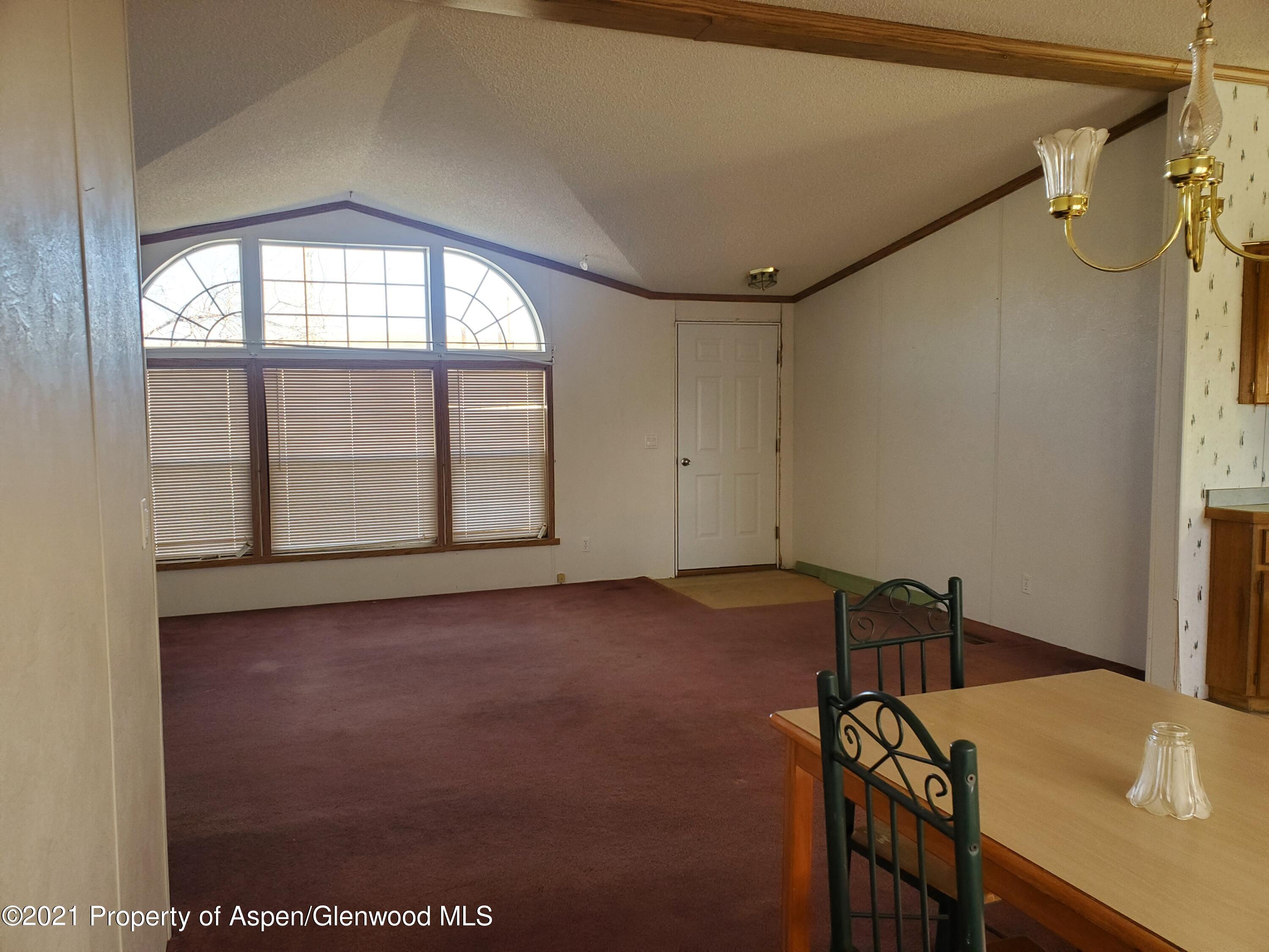 275 Roberts Road Craig, CO 81625 - Photo 8 of 16 a view of a room that has a bed and a table in it