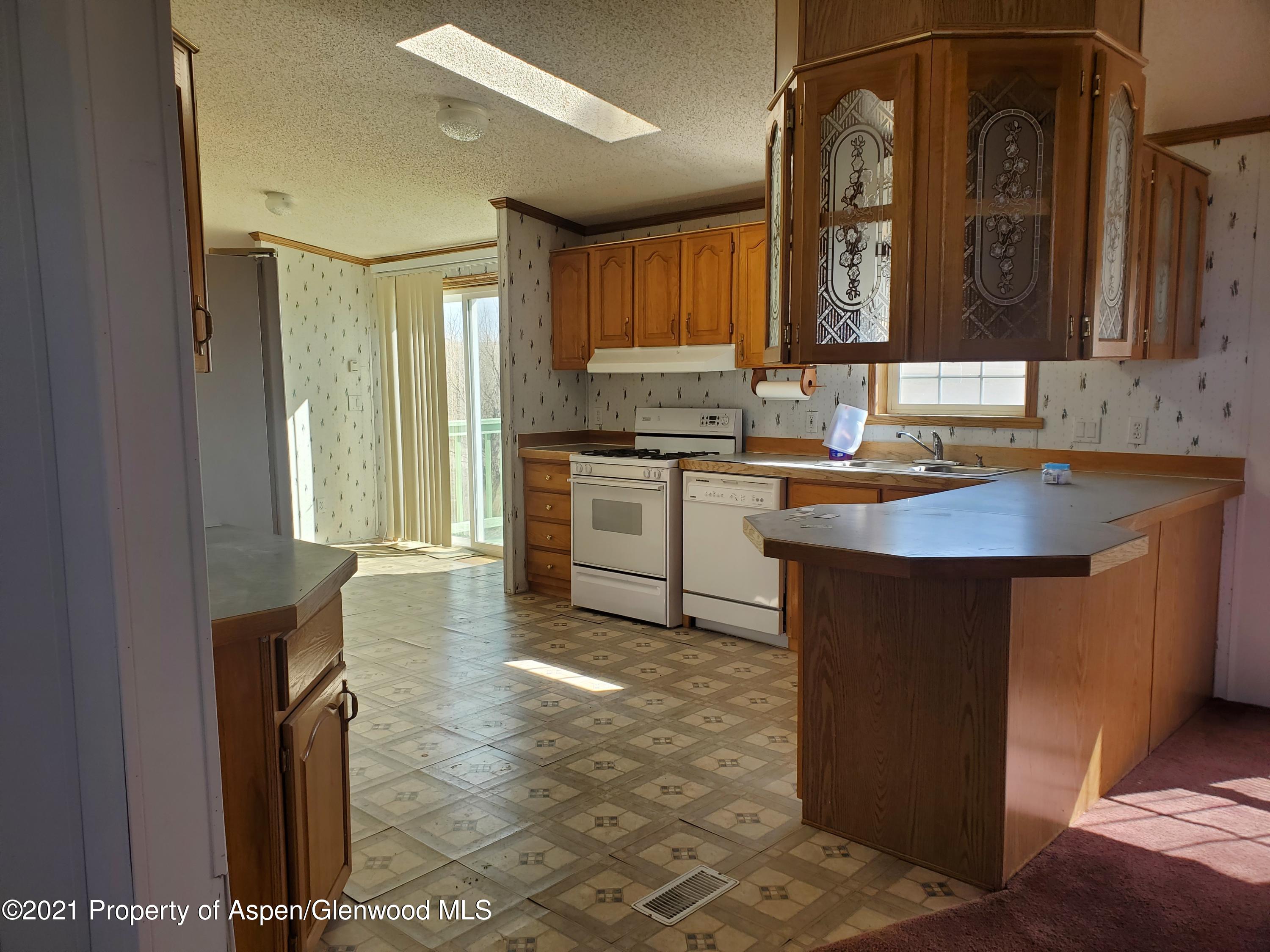 275 Roberts Road Craig, CO 81625 - Photo 9 of 16 a kitchen with a sink stove and cabinets