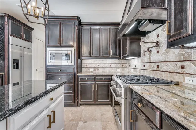 a kitchen with stainless steel appliances granite countertop a stove and a sink