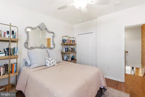 a bedroom with a bed and a book shelf