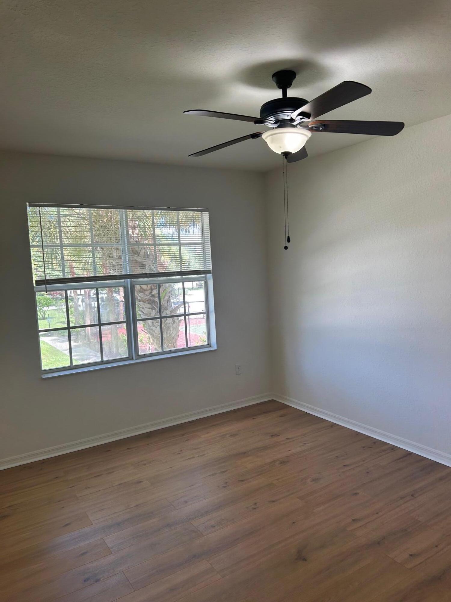 272 Southeast Kitching Circle Stuart, FL 34994 - Photo 11 of 23 wooden floor in an empty room with a window