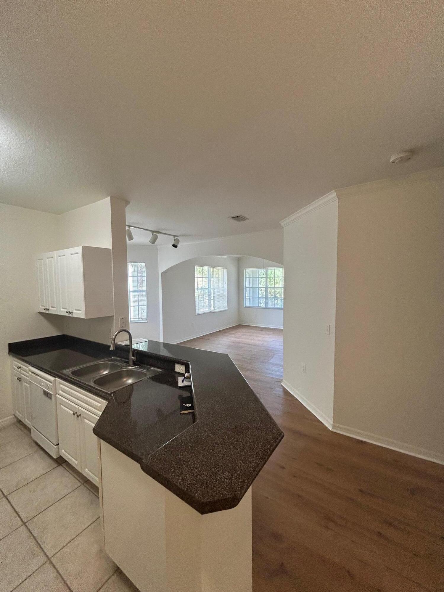 272 Southeast Kitching Circle Stuart, FL 34994 - Photo 16 of 23 a kitchen with granite countertop a sink a stove and cabinets