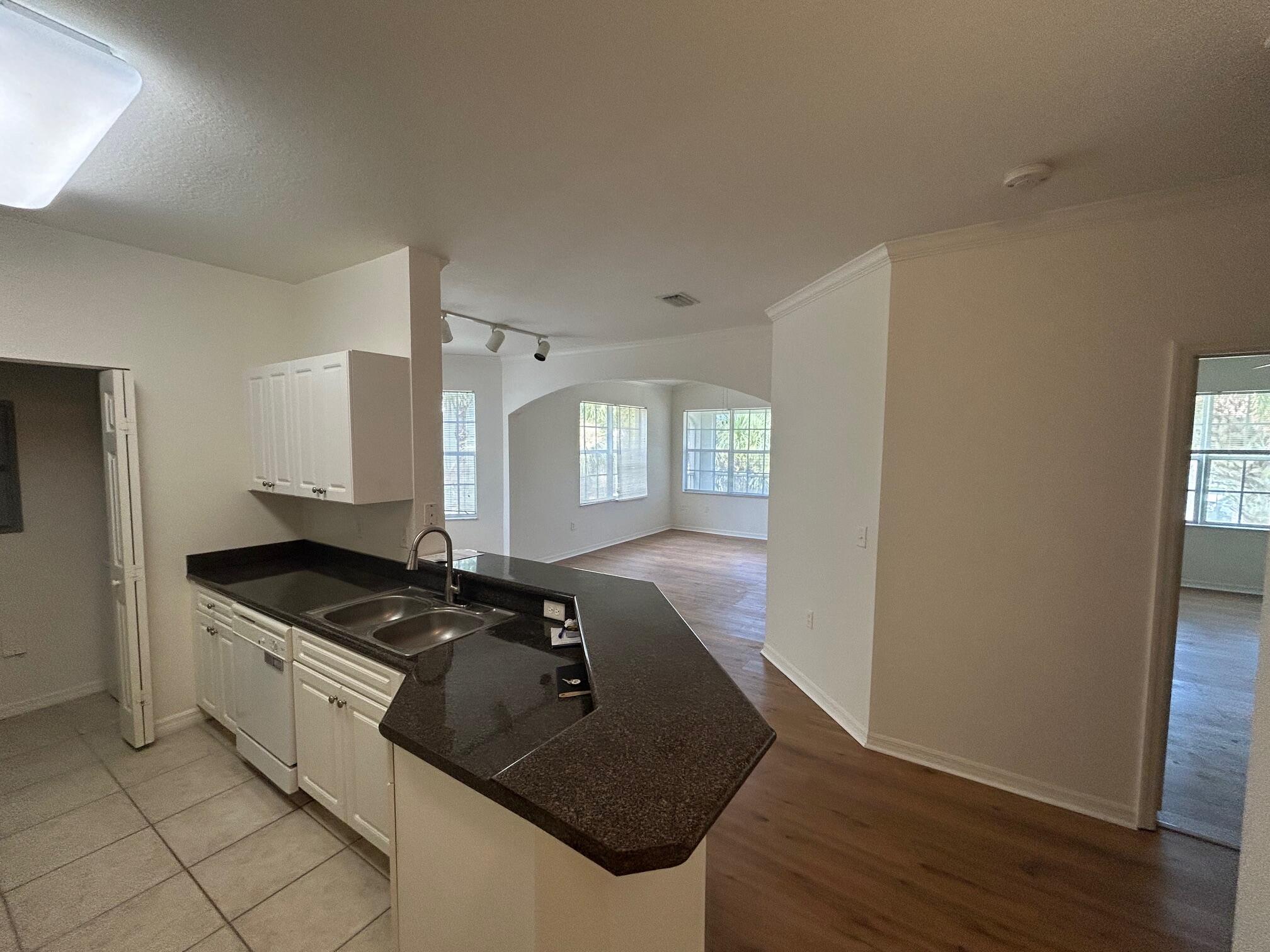 272 Southeast Kitching Circle Stuart, FL 34994 - Photo 17 of 23 a kitchen with granite countertop a sink and a stove top oven