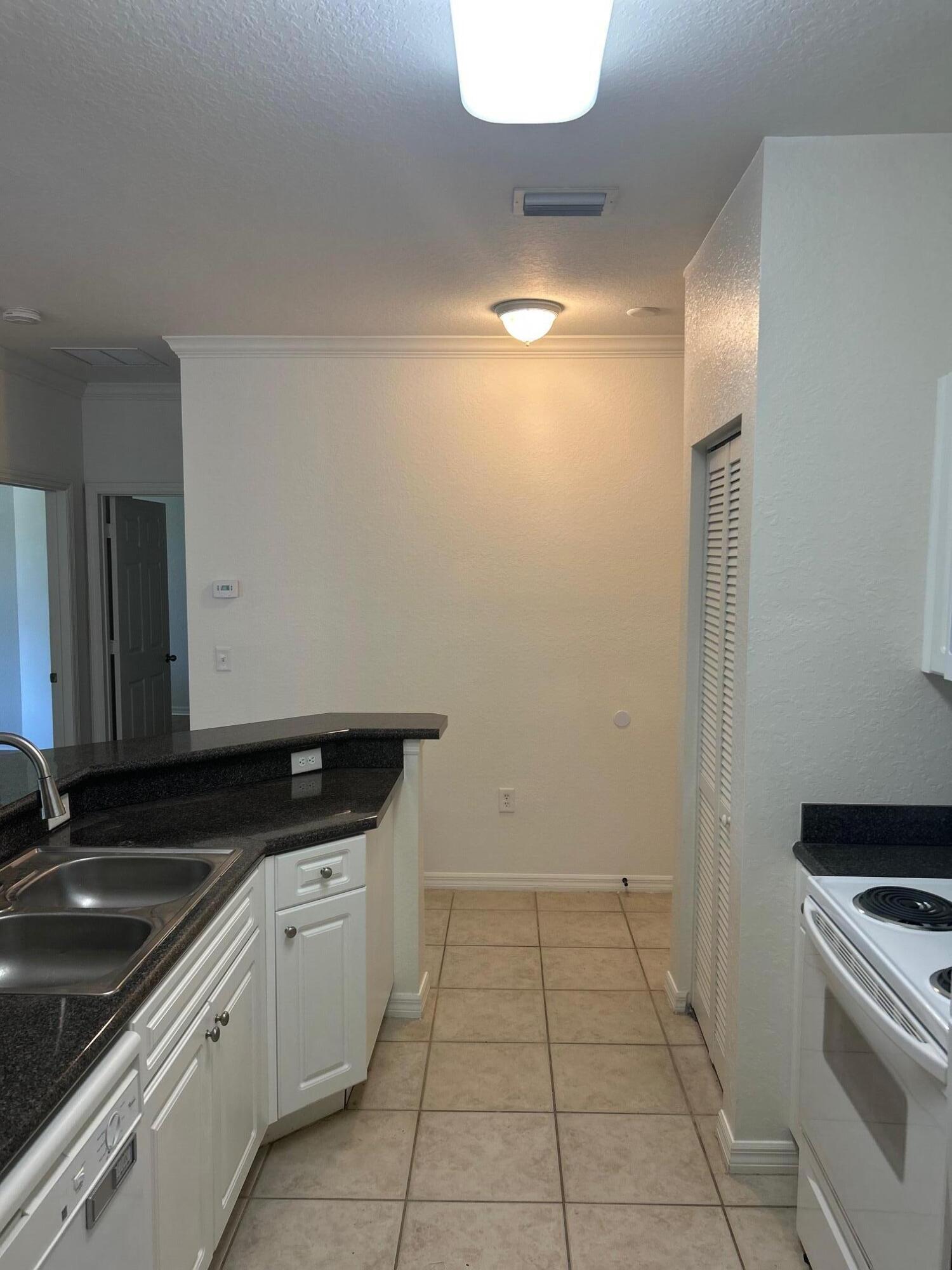 272 Southeast Kitching Circle Stuart, FL 34994 - Photo 20 of 23 a kitchen with a sink and cabinets