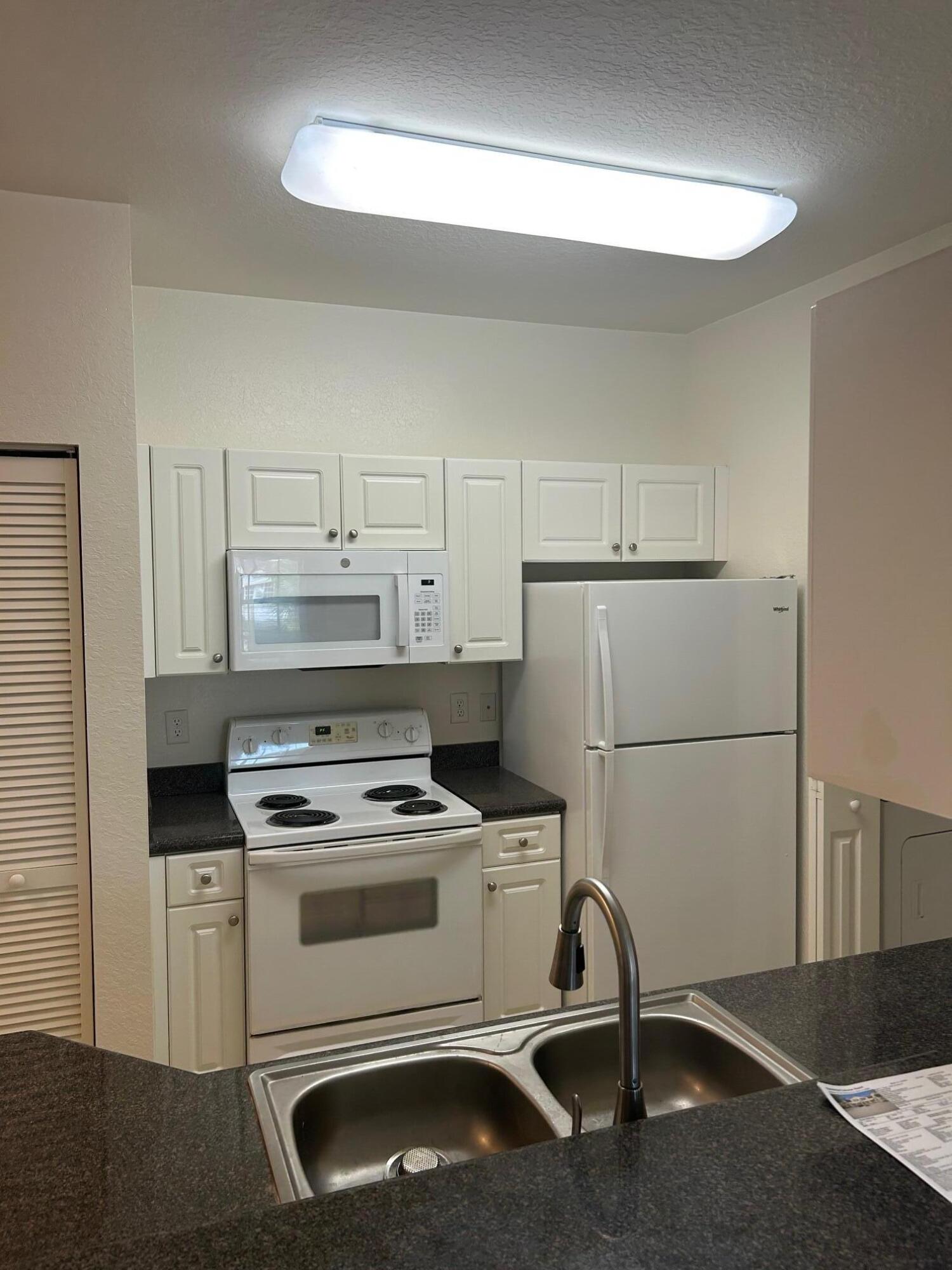 272 Southeast Kitching Circle Stuart, FL 34994 - Photo 22 of 23 a kitchen with a stove and a refrigerator