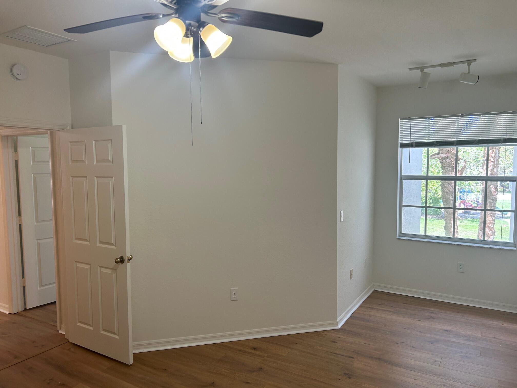 272 Southeast Kitching Circle Stuart, FL 34994 - Photo 7 of 23 wooden floor in an empty room with a window