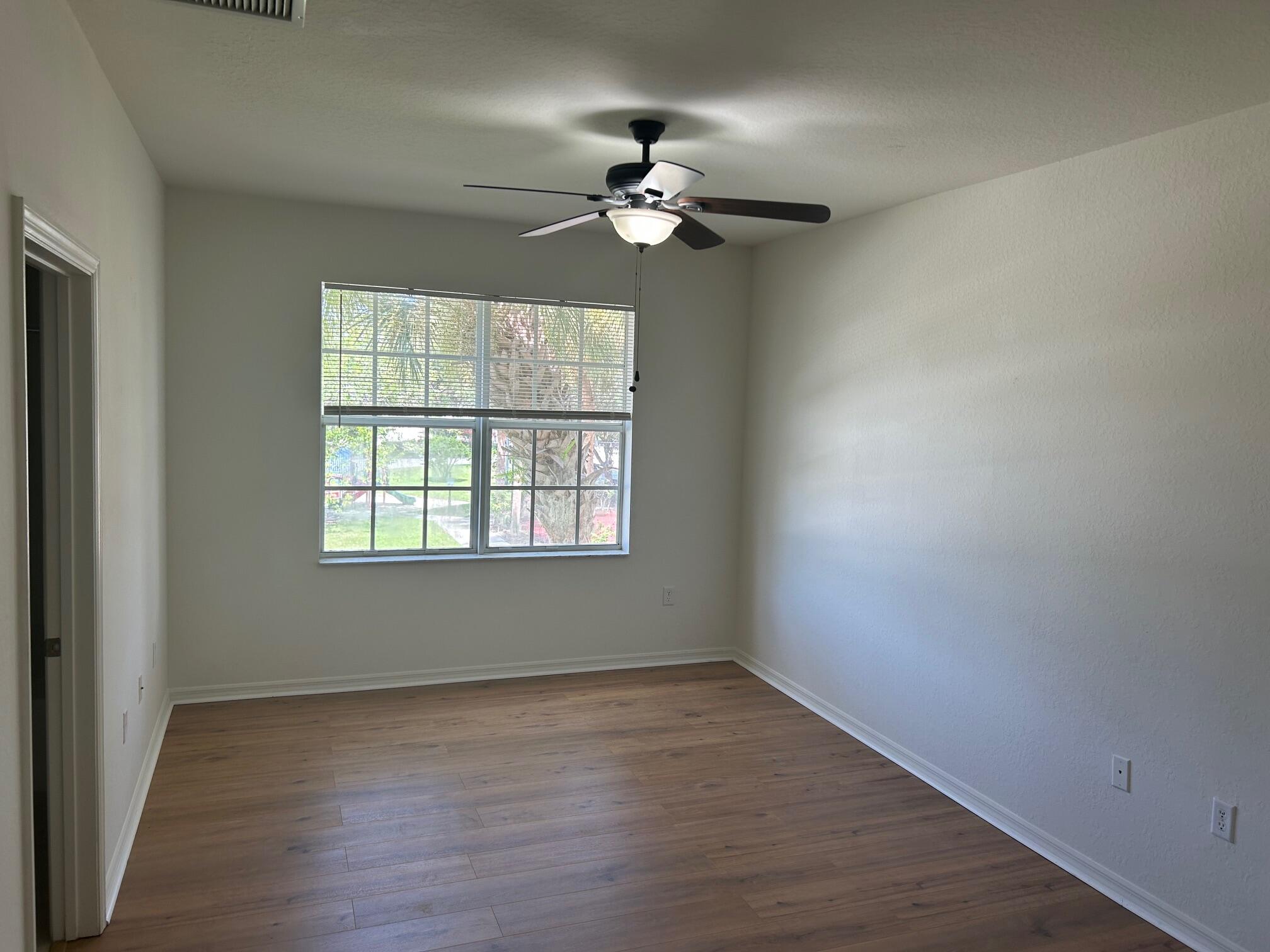 272 Southeast Kitching Circle Stuart, FL 34994 - Photo 8 of 23 wooden floor in an empty room with a window