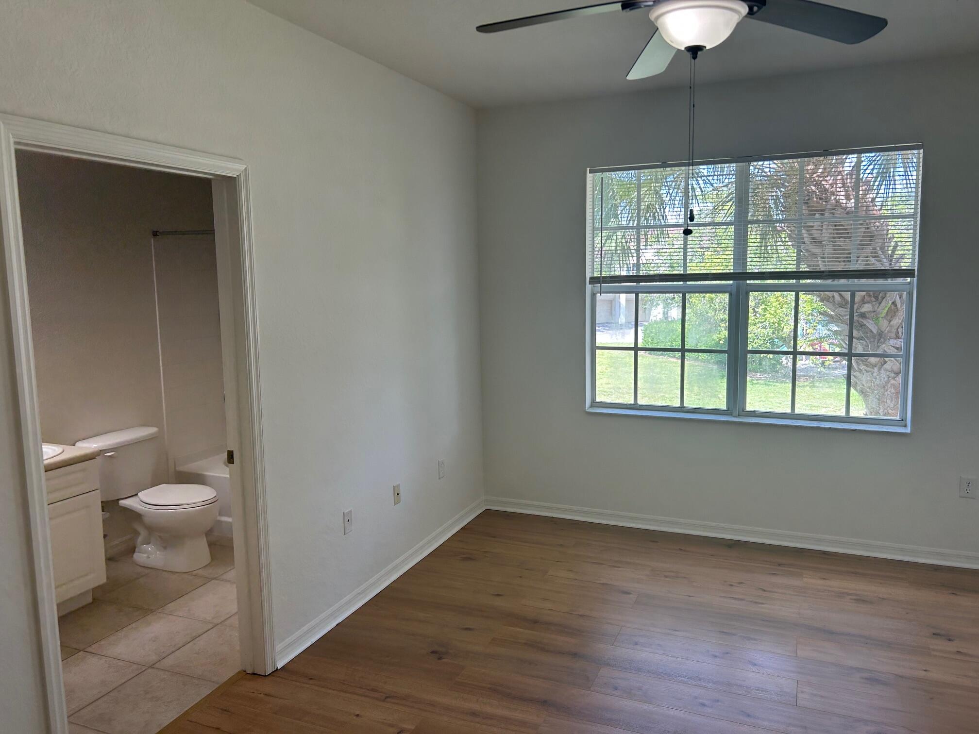 272 Southeast Kitching Circle Stuart, FL 34994 - Photo 10 of 23 a bathroom with a toilet sink and a window