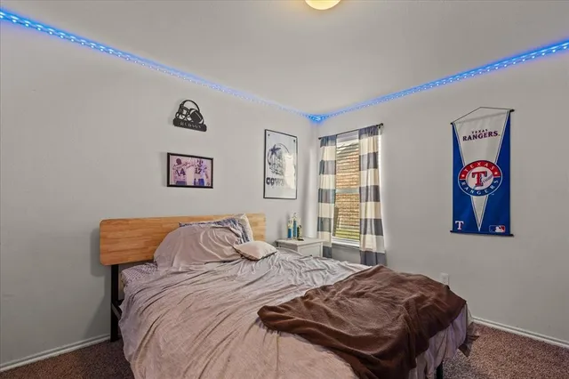 a bedroom with bed and wall painting with wooden floor