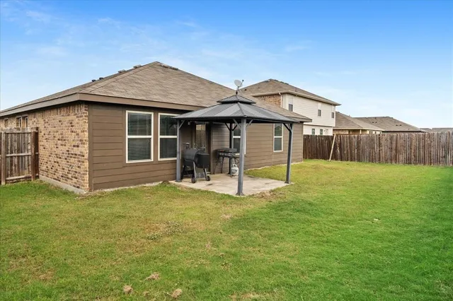 a view of a house with a yard and a porch