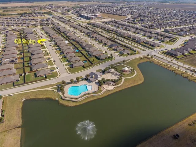 an aerial view of a house with a lake view
