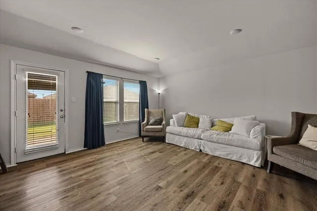 a living room with furniture and two window