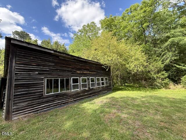 3415 Mt Willing Road Efland, NC 27243 - Photo 29 of 36 a backyard of a house with large trees and wooden fence