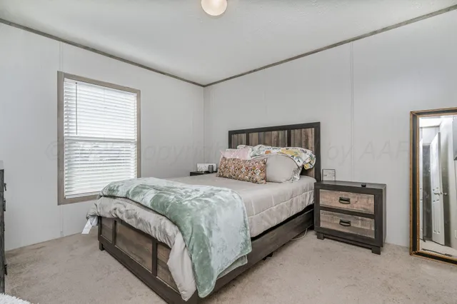 a bed sitting in a bedroom next to a window