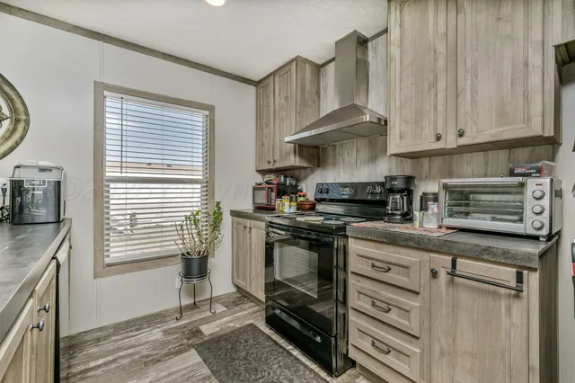 a kitchen with stainless steel appliances granite countertop a sink a stove and a microwave