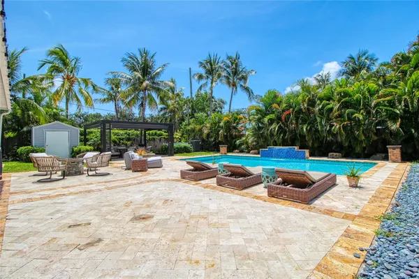 a view of a backyard with sitting area