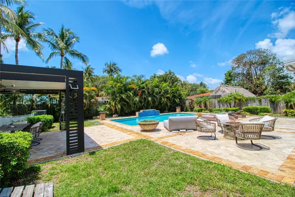a view of a patio with table and chairs and potted plants