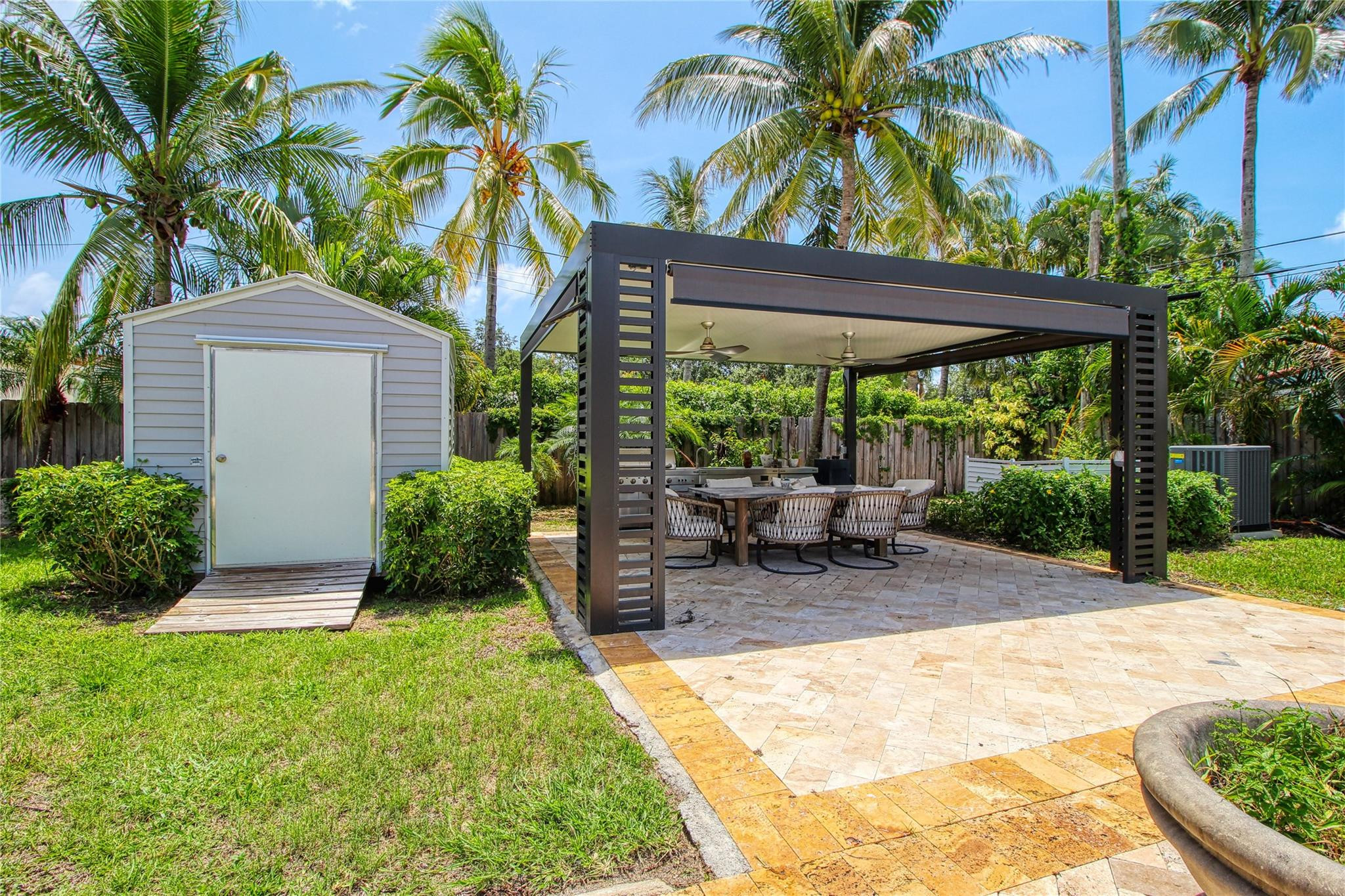 2080 Northeast 26th Street Lighthouse Point, FL 33064 - Photo 17 of 27 a view of a patio with table and chairs under an umbrella