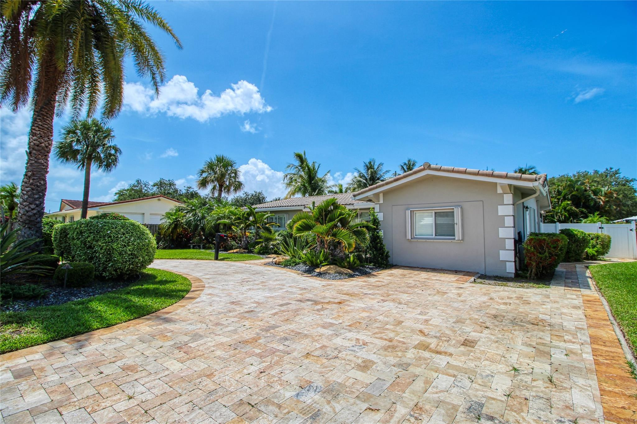 2080 Northeast 26th Street Lighthouse Point, FL 33064 - Photo 2 of 27 a view of a house with a yard and potted plants