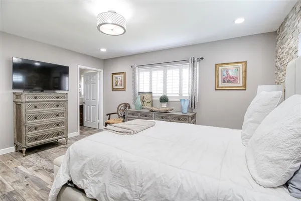 a bathroom with a granite countertop toilet a sink and a mirror