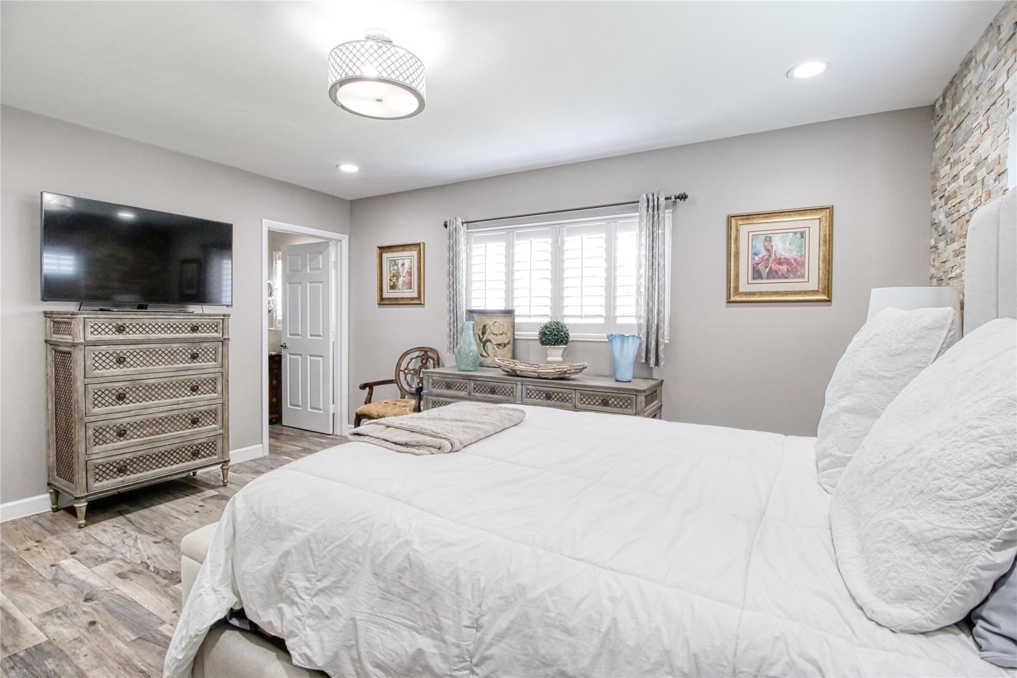 2080 Northeast 26th Street Lighthouse Point, FL 33064 - Photo 21 of 27 a bedroom with a bed and a flat screen tv