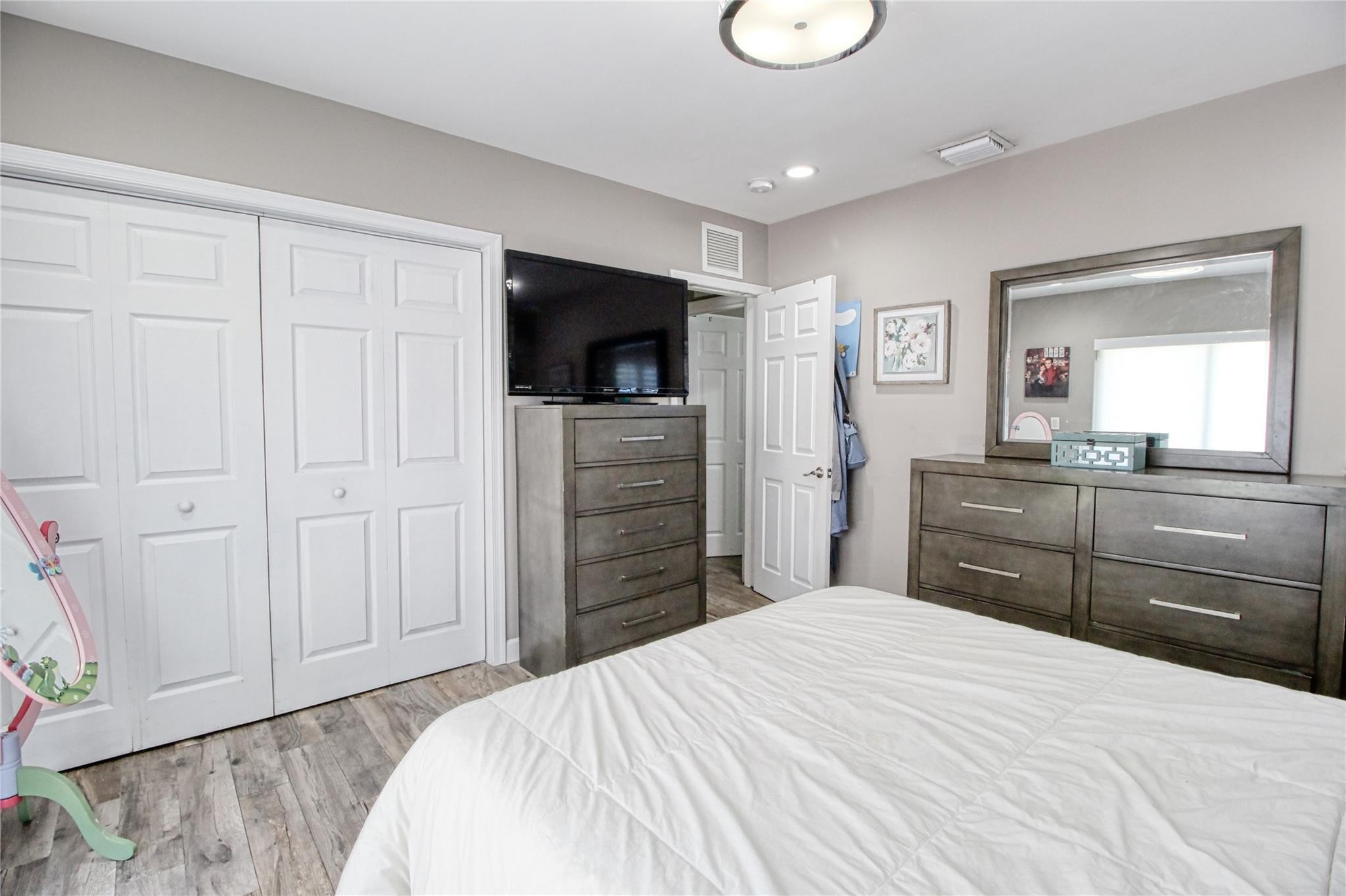 2080 Northeast 26th Street Lighthouse Point, FL 33064 - Photo 24 of 27 a bedroom with a bed and a flat screen tv