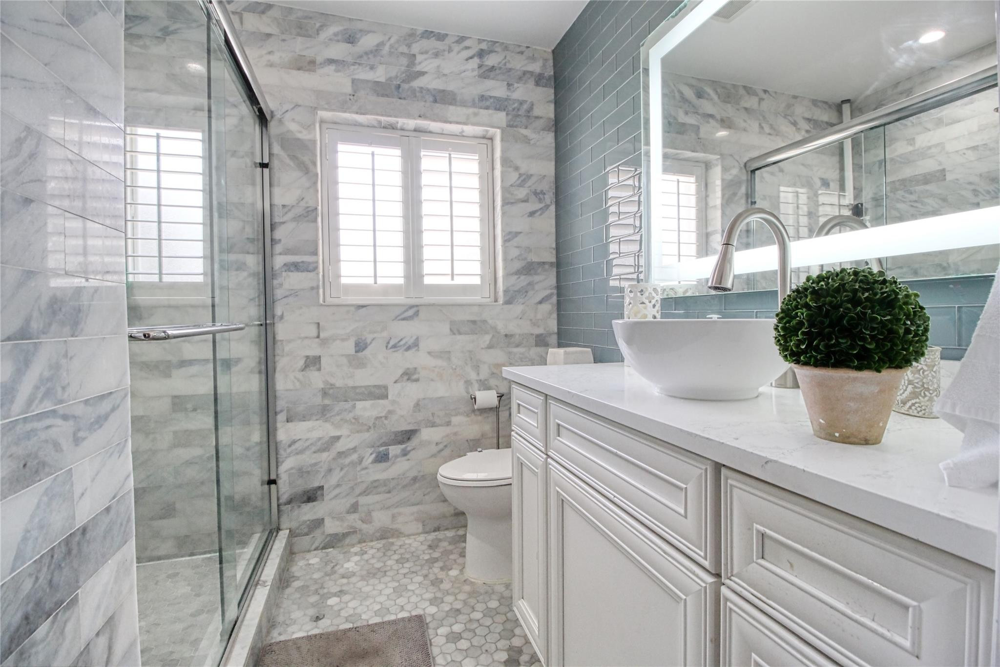 2080 Northeast 26th Street Lighthouse Point, FL 33064 - Photo 25 of 27 a bathroom with a sink a toilet and potted