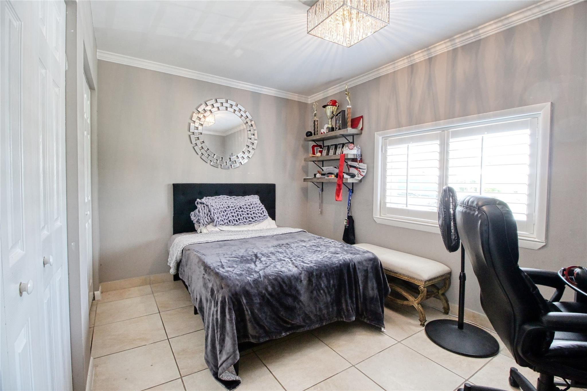 2080 Northeast 26th Street Lighthouse Point, FL 33064 - Photo 27 of 27 a bedroom with a bed and a chandelier