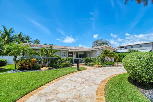 a front view of a house with a yard and outdoor seating