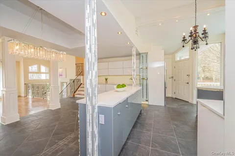 a large white kitchen with a large window