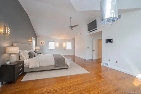 a spacious bedroom with a bed a table and chairs