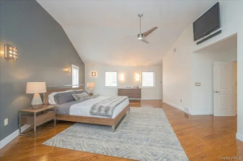 a bedroom with a large bed and a chandelier