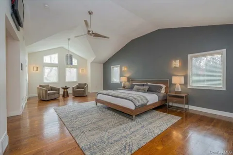 a spacious bedroom with a bed a table and chairs