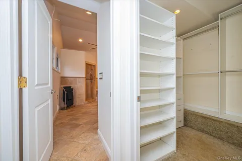 a view of a hallway with a wooden shelves