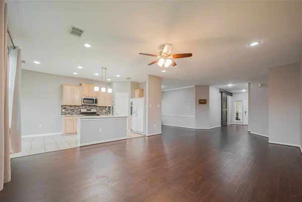 a kitchen with granite countertop a stove a sink and a white cabinets